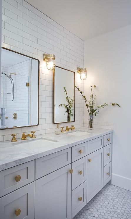 Well appointed light gray and white basement bathroom features two Restoration H...