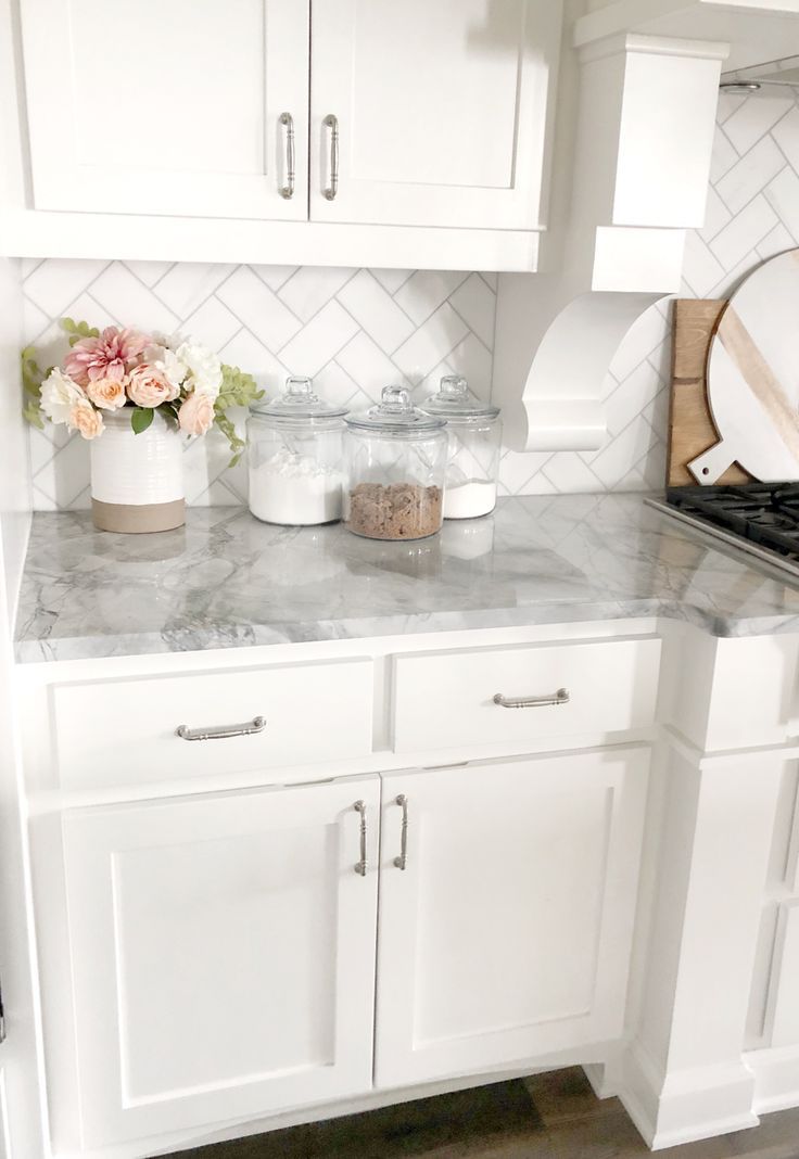 white kitchen with gray marble counter top and white subway tile back splash #wh...