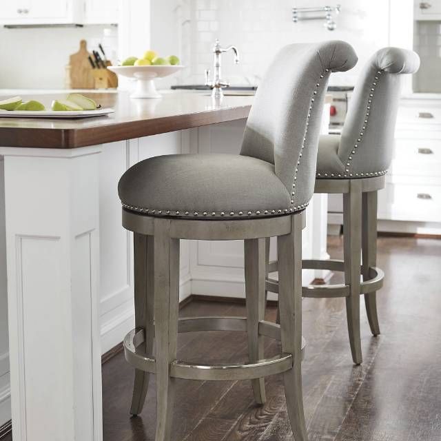 The graceful silhouette and curved back of our Ellison Barstool .