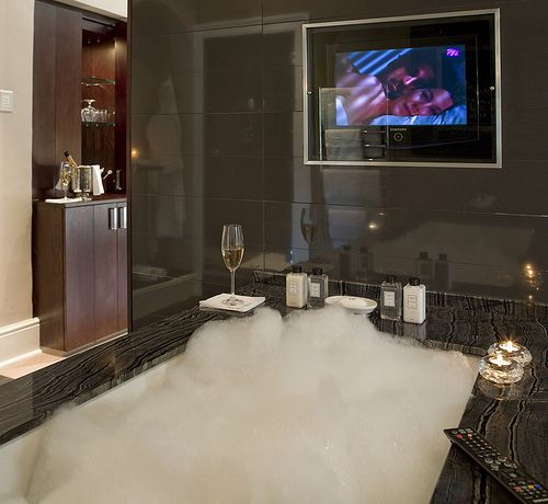 Seriously?! A bubble bath, liquor cabinet, flat screened tv and .