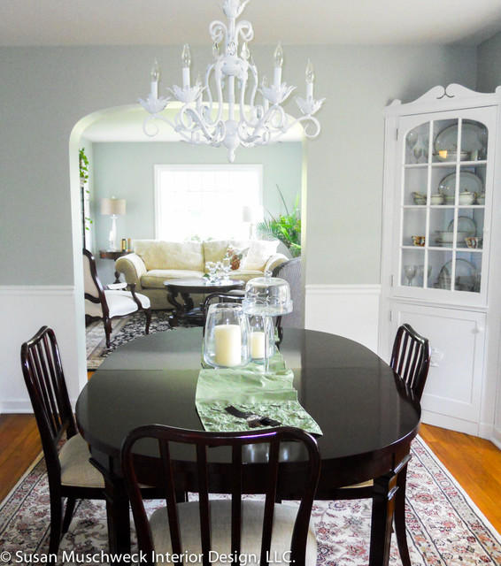 Traditional Dining Room with White Chandelier and Dark Table .