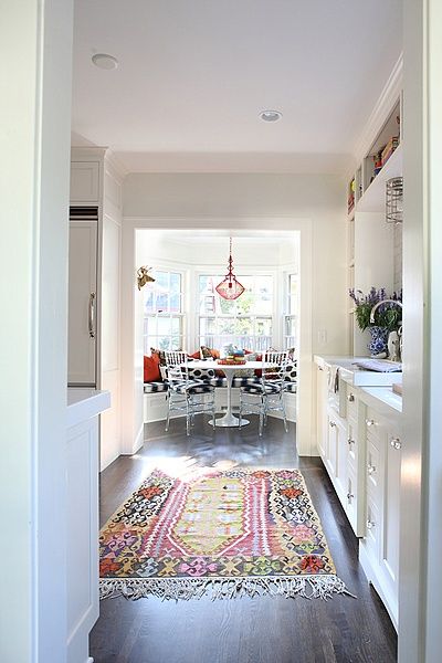 A colorful oriental rug adorns a galley kitchen by Jamie Meares .