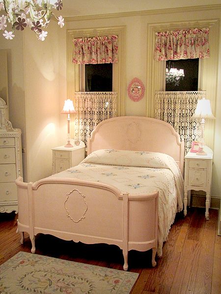 Pink vintage room with full size bed mildly distressed .